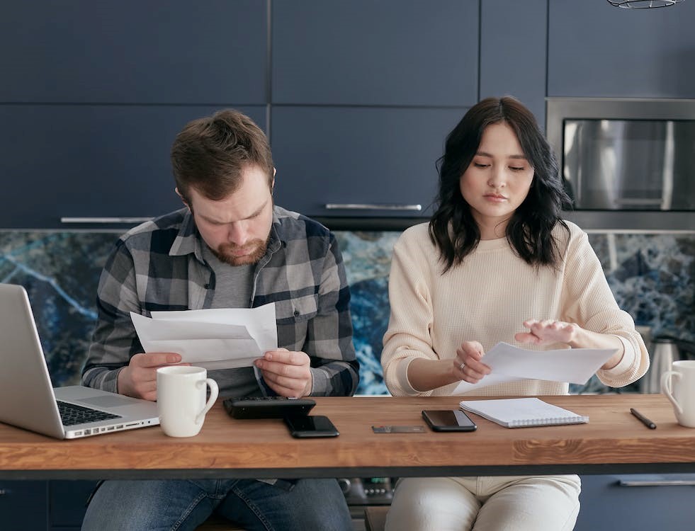 A couple figuring out payday loan debt consolidation.